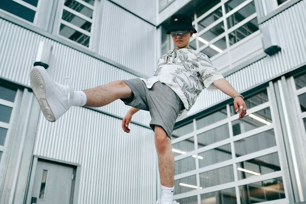 Young person balancing on one leg in a modern room